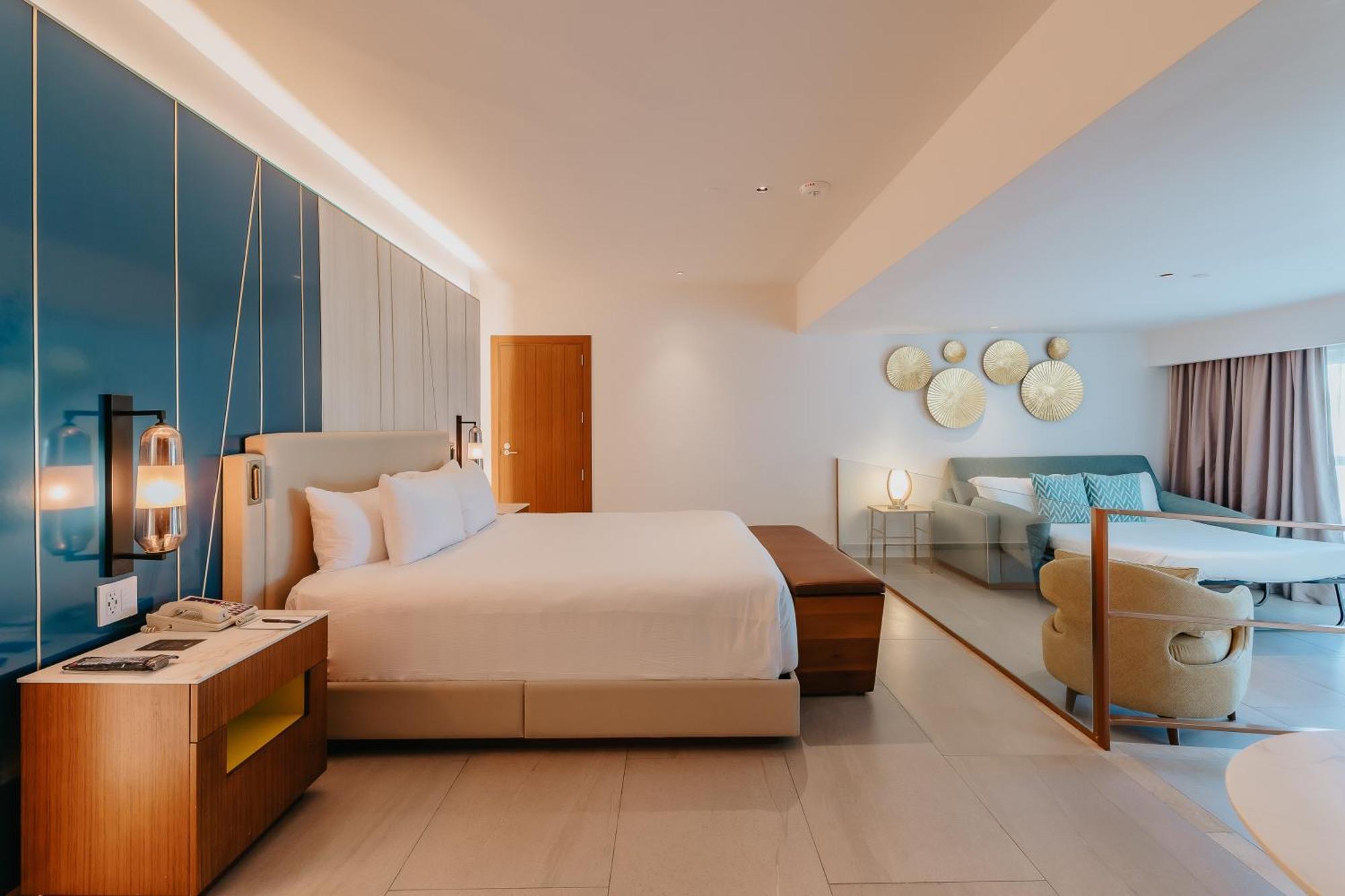 Suíte caribbean com acessibilidade, cama king-size e sofá-cama